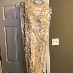 It’s a off white dress with pearls and sequence it has a small train on back